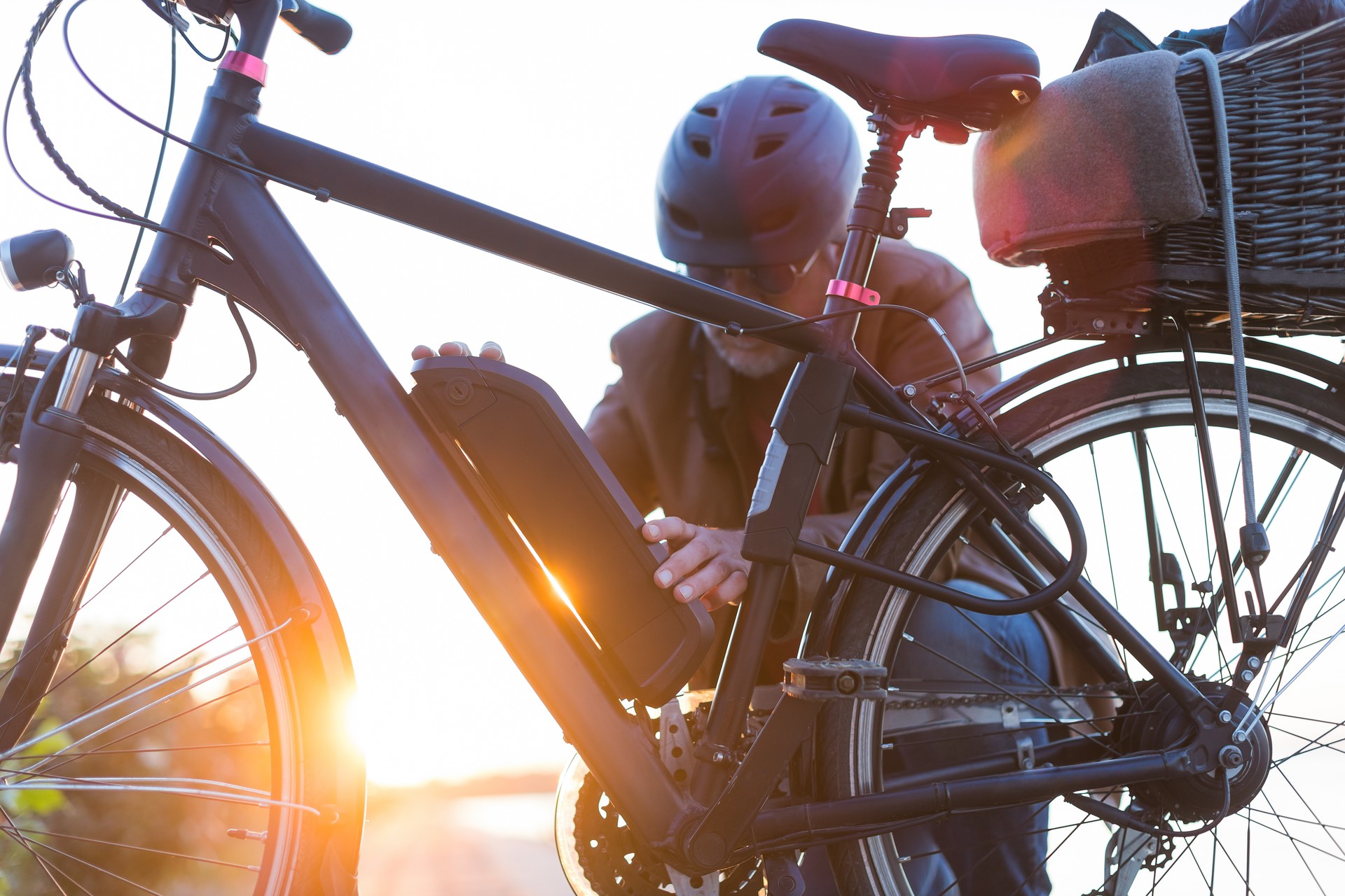 man changing electric bicycle battery