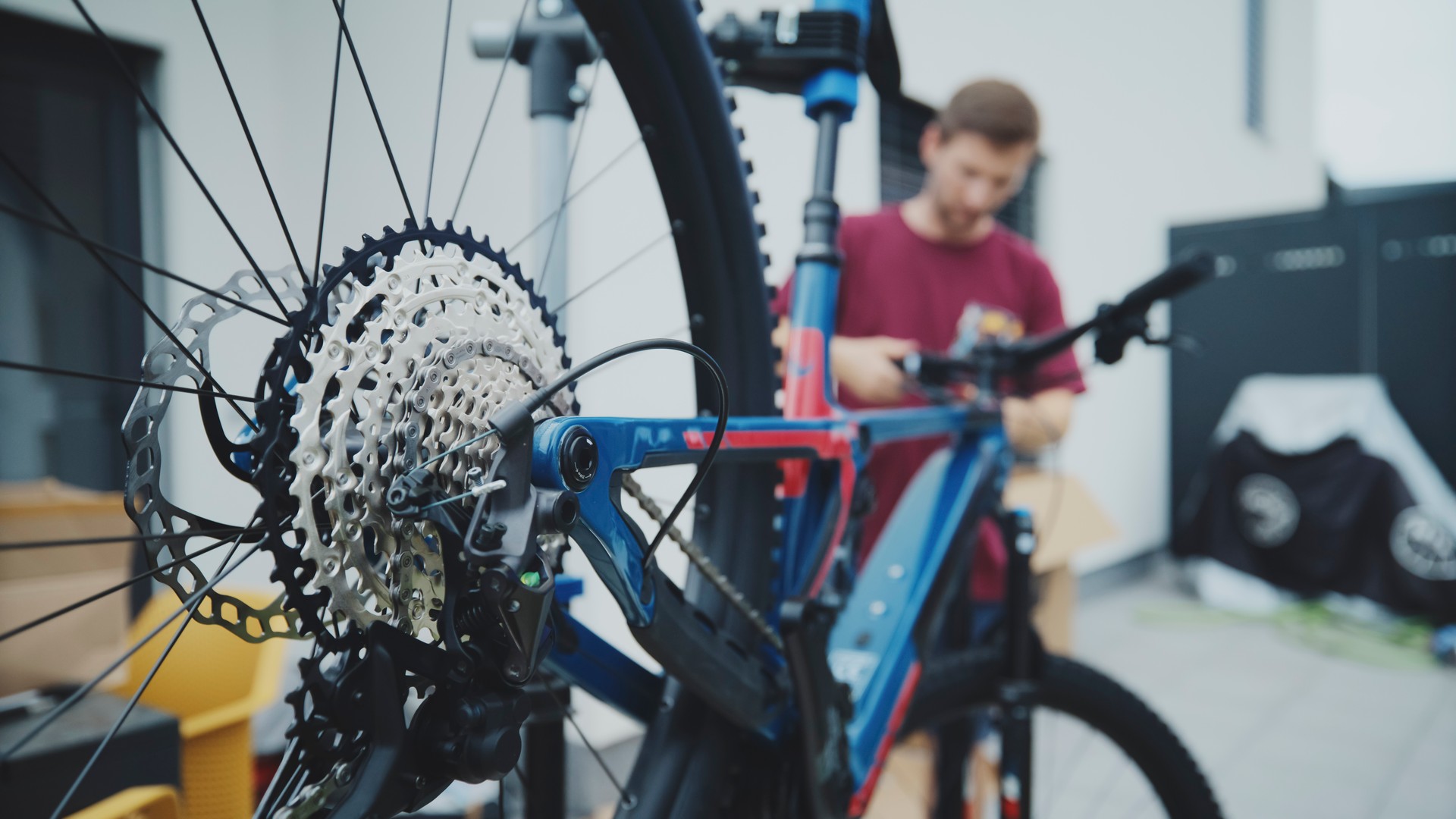 Upside Down Mountain Bike at Yard with Man Standing in Background